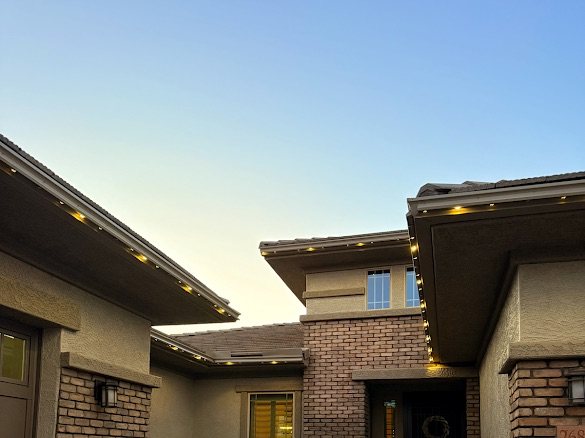 Brick home at twilight with warm permanent LED outline
