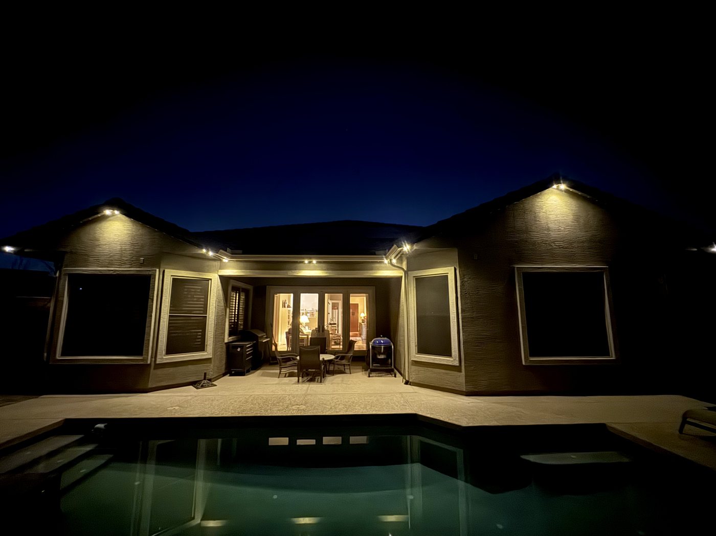 Pool and deck area lit by integrated property lighting
